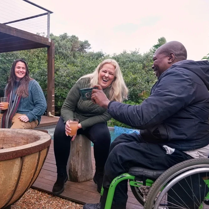 Group of disabled friends chatting on rooftop